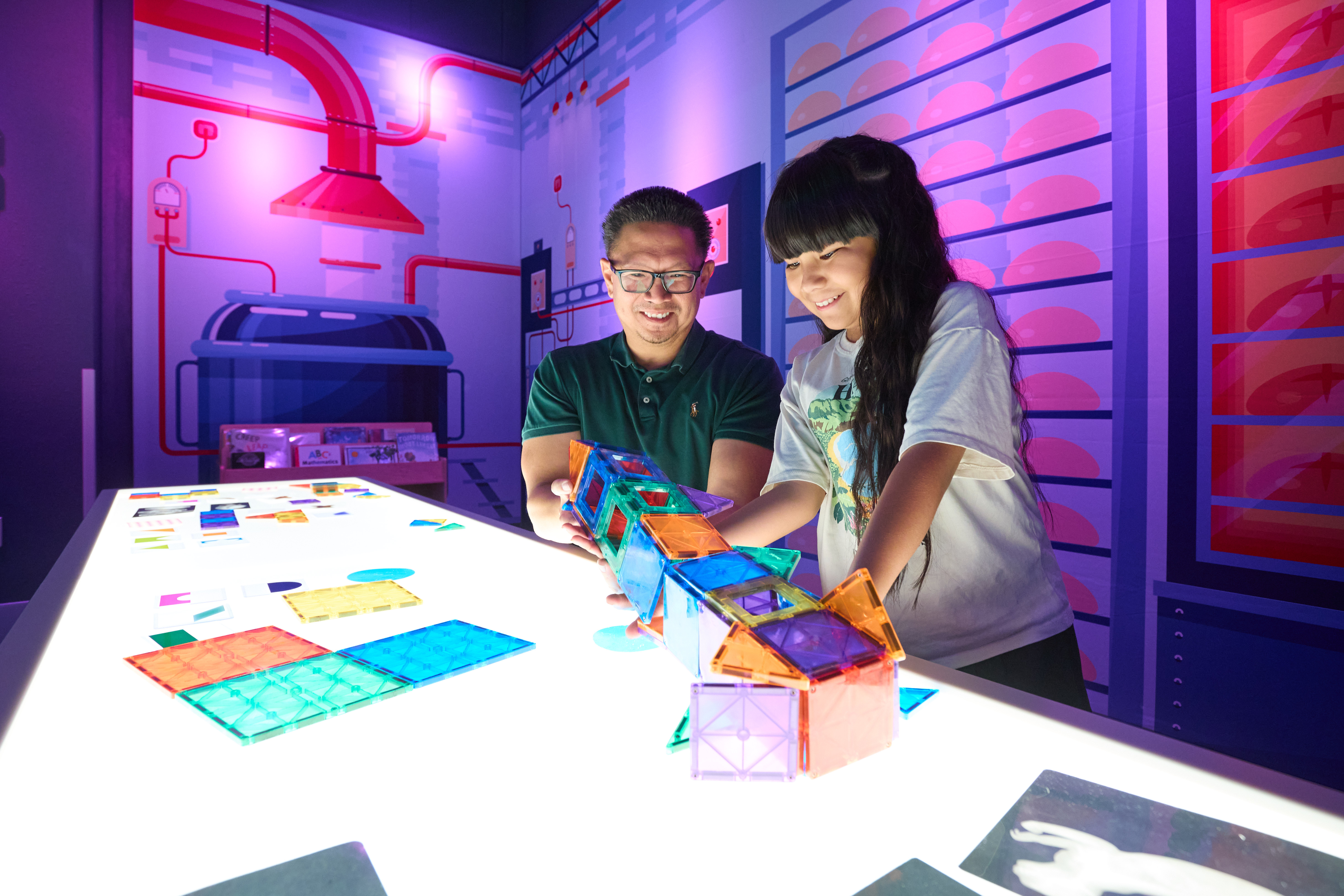 A father and his daughter playing with blocks in the Sensory Room of Second Story and Beyond
